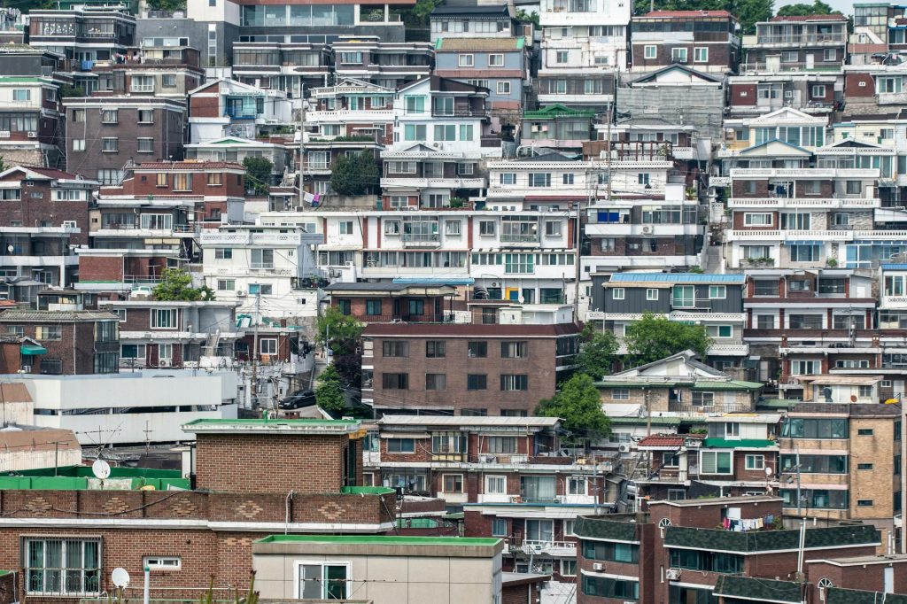 Seoul skyline of luxury high-rise apartments beside an older low-rise residential district
