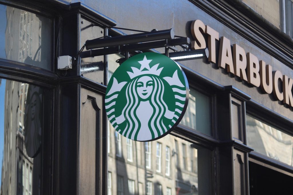 A Starbucks storefront with the green logo on a South Korean city street