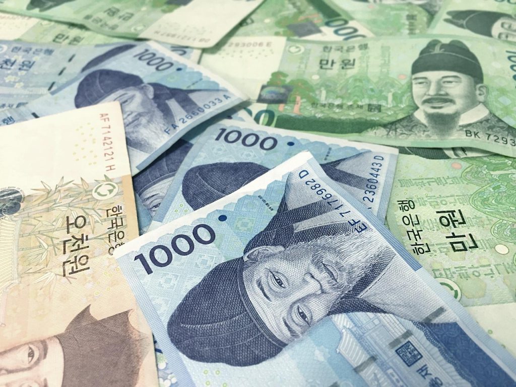 Digital stock tickers showing rising index numbers on a modern Korean exchange trading floor