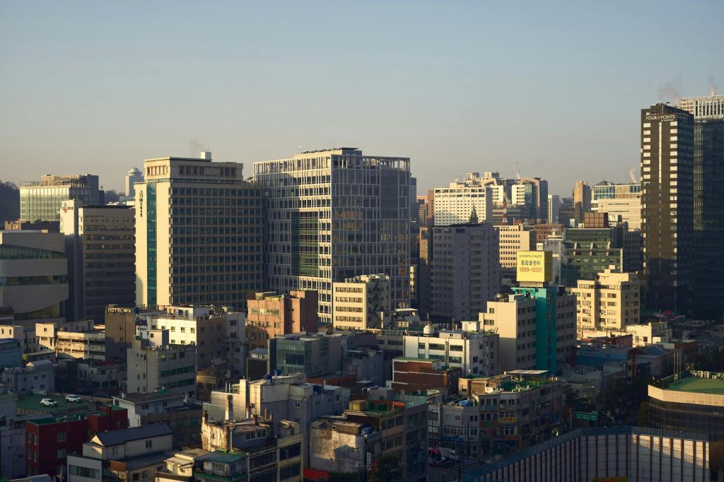 Glass corporate office towers in a Seoul financial district under daytime sky