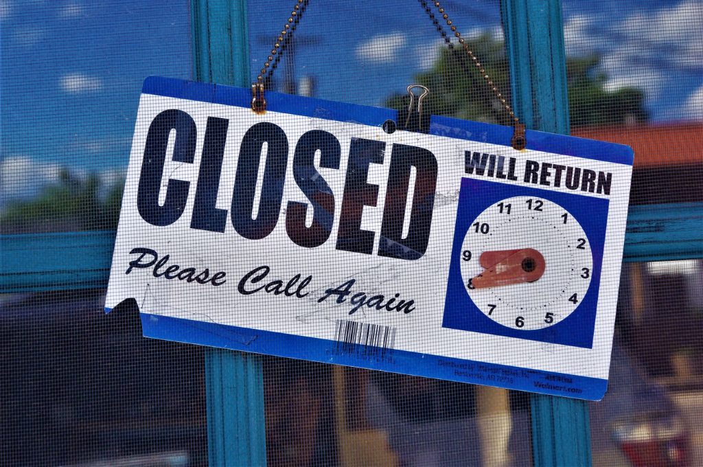 Closed entrance of a large Korean hypermarket store with shutters down and a notice on the glass doors