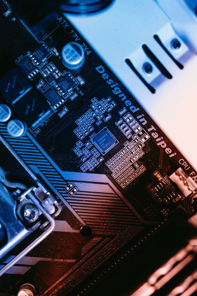 Close-up of an advanced memory semiconductor chip on a silicon wafer with blue server racks behind it