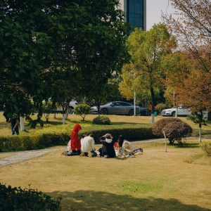 Residents and children gathering on the green central lawn of a modern apartment complex in South Korea