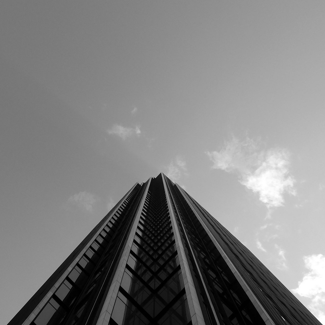 Lone businessperson looking up at a high-rise tower in Seoul's financial district