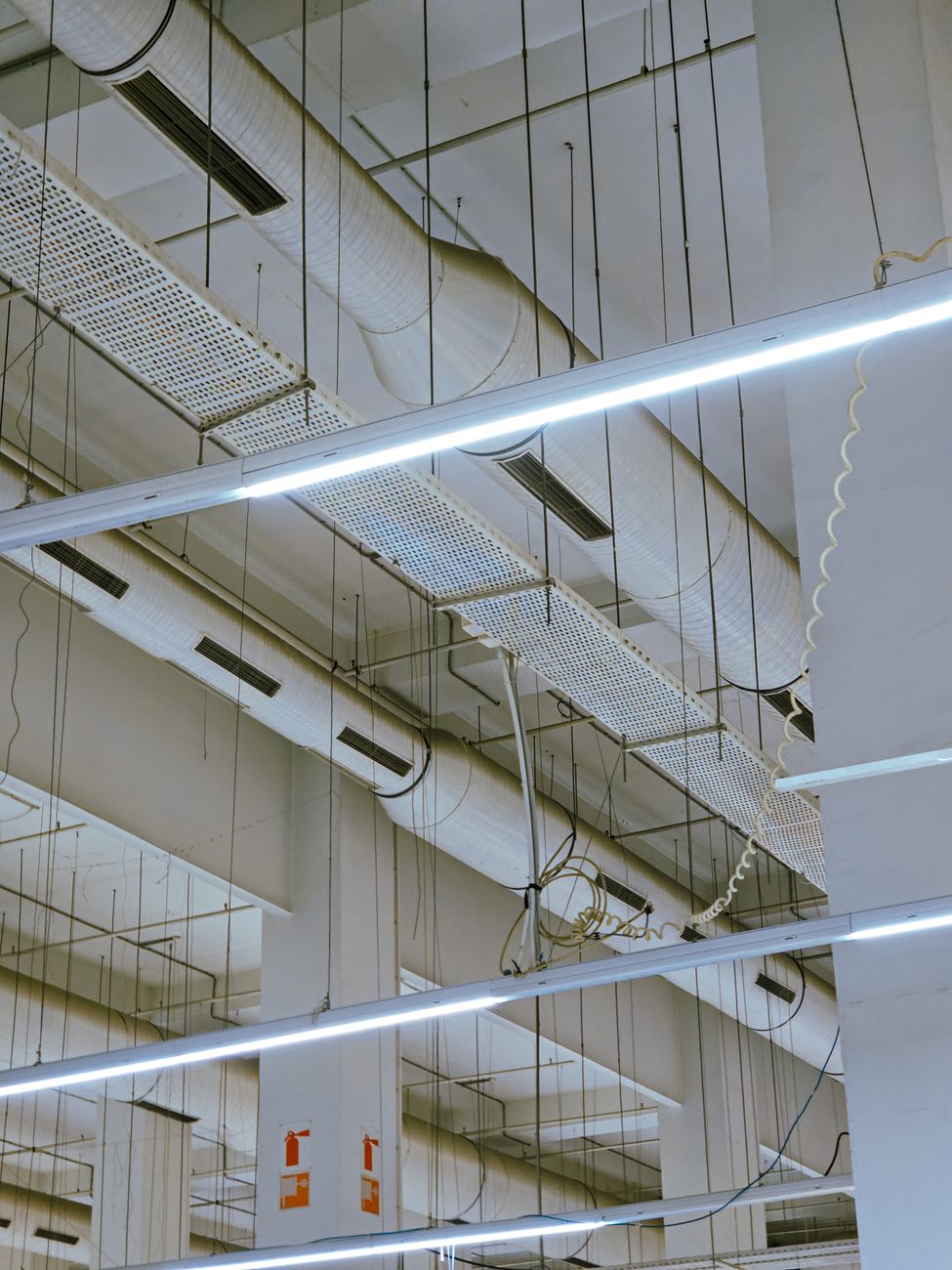 Interior of a data center showing rows of server racks and large cooling units